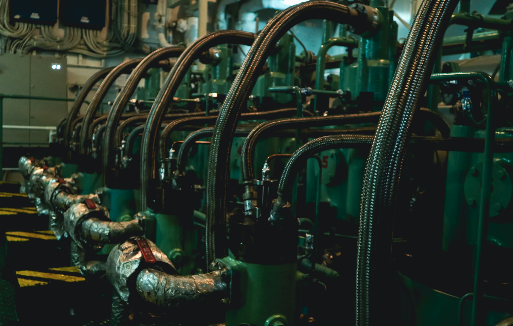Rows of pipes and machinery in an engine room