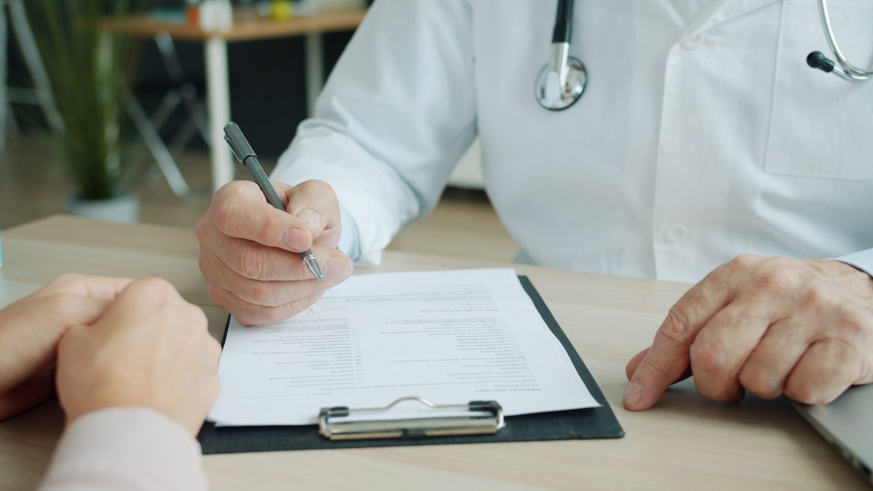 A doctor and patient going through documents together