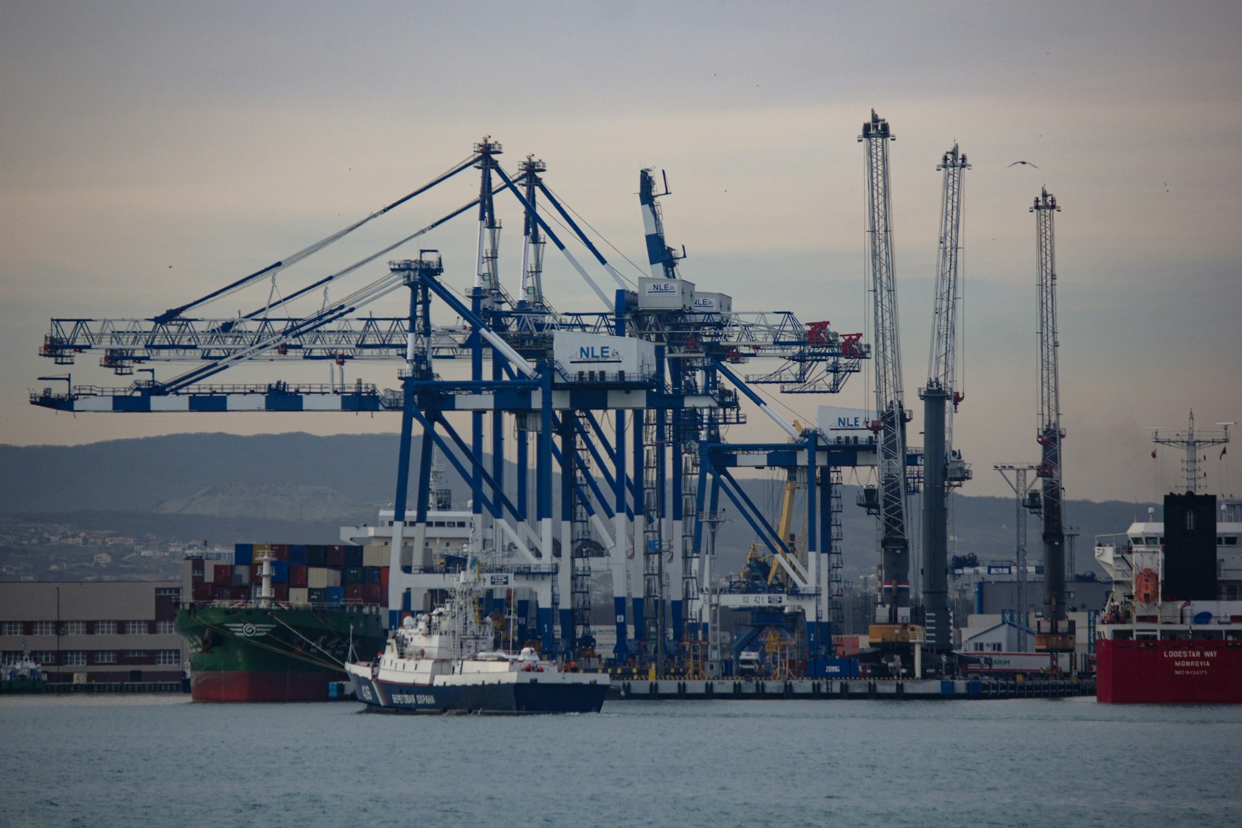 Container cranes and a cargo ship at a busy port