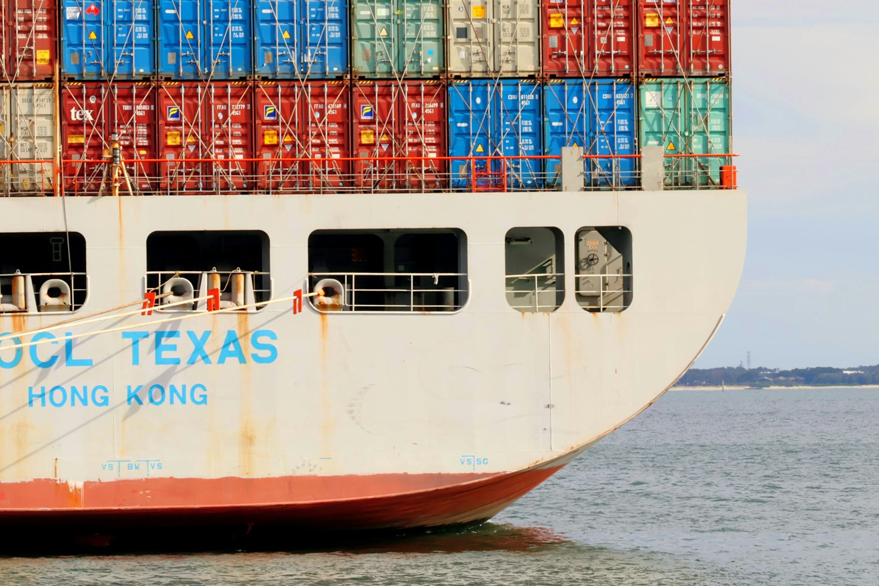 A cargo ship stacked with colourful containers